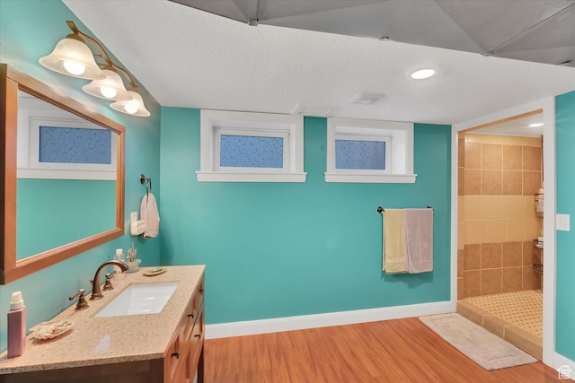 155 W 500 N, Logan, UT 84321 - full bath with wood finished floors, vanity, tiled shower, and recessed lighting