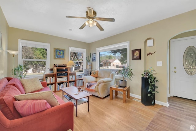 155 W 500 N, Logan, UT 84321 - living room with a ceiling fan, light wood-style flooring, and arched walkways
