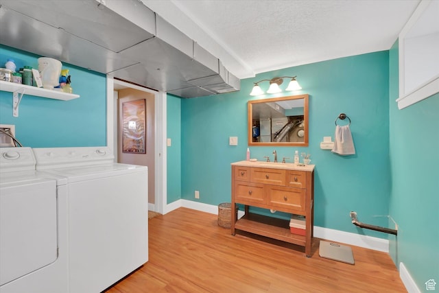 155 W 500 N, Logan, UT 84321 - laundry area with washer and dryer, light wood finished floors, and a textured ceiling