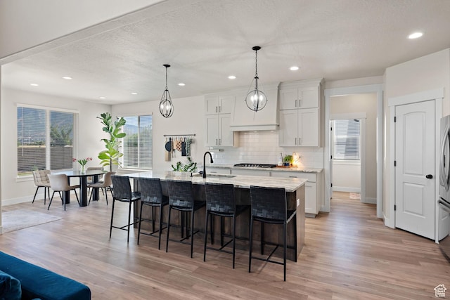 3056 E 80 S, Spanish Fork, UT 84660 - kitchen with a kitchen breakfast bar, light wood finished floors, tasteful backsplash, recessed lighting, and a textured ceiling