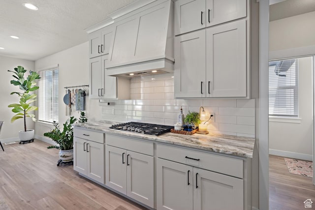 3056 E 80 S, Spanish Fork, UT 84660 - kitchen featuring custom range hood, light wood-style floors, backsplash, recessed lighting, and light stone countertops