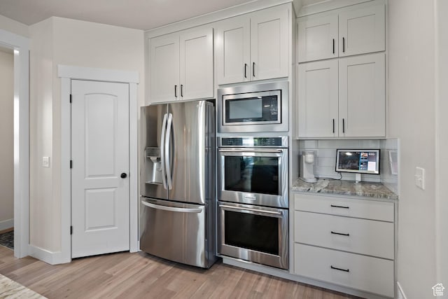 3056 E 80 S, Spanish Fork, UT 84660 - kitchen with appliances with stainless steel finishes, light wood finished floors, light stone counters, and backsplash