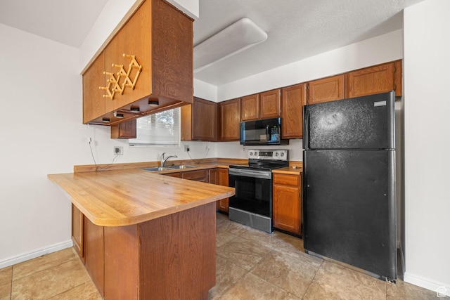 5608 S 700 W, Murray, UT 84123 - kitchen with a peninsula, black appliances, brown cabinets, wood counters, and a kitchen bar