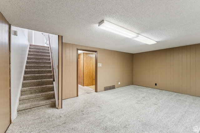750 E Three Fountains Dr Unit 96, Murray, UT 84107 - finished below grade area with carpet floors, a textured ceiling, stairway, and wooden walls