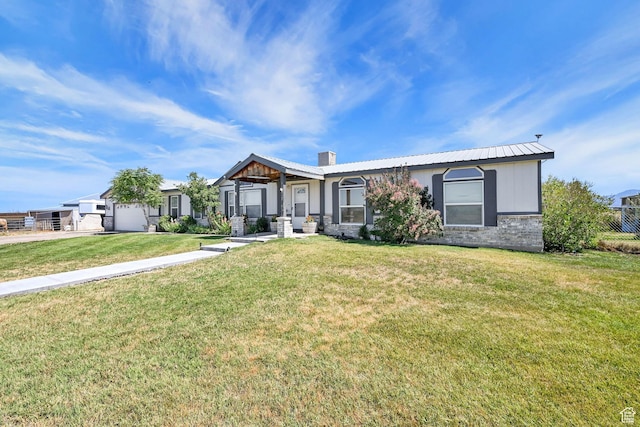 4171 W 2425 N, Hooper Davis Cnty, UT 84315 - view of front of property with a chimney, a garage, a front lawn, a metal roof, and brick siding