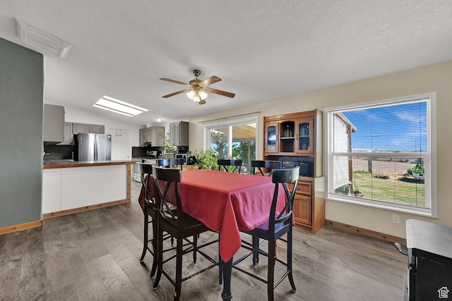 4171 W 2425 N, Hooper Davis Cnty, UT 84315 - dining space with light wood-style flooring, a textured ceiling, and ceiling fan