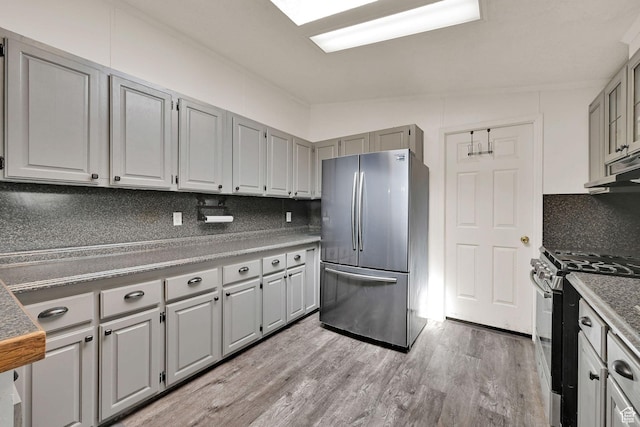 4171 W 2425 N, Hooper Davis Cnty, UT 84315 - kitchen with stainless steel appliances, decorative backsplash, gray cabinetry, and light wood-style flooring
