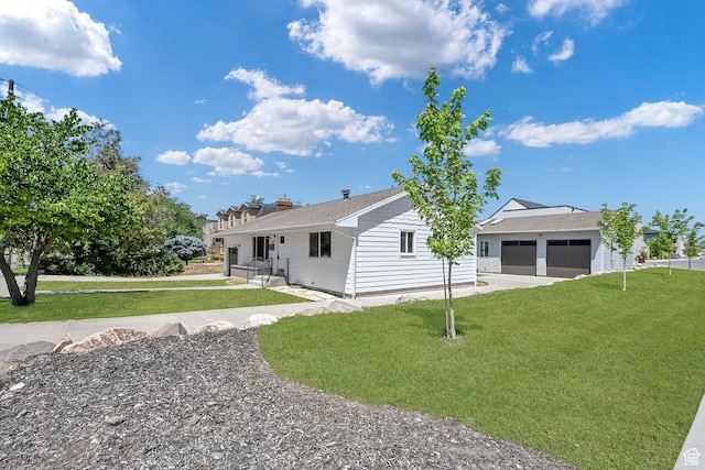 648 W Porter Ln, Centerville, UT 84014 - rear view of house with driveway, a yard, a garage, and a chimney
