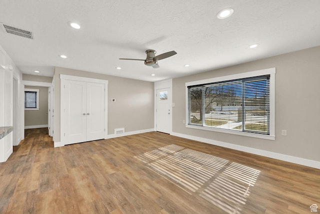 648 W Porter Ln, Centerville, UT 84014 - unfurnished living room featuring ceiling fan, recessed lighting, and wood finished floors