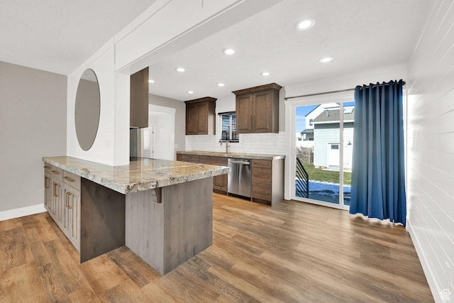 648 W Porter Ln, Centerville, UT 84014 - kitchen with a peninsula, light wood-type flooring, recessed lighting, dishwasher, and backsplash
