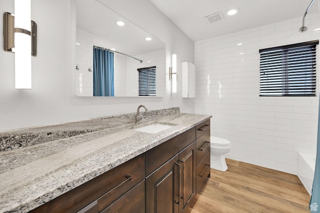 648 W Porter Ln, Centerville, UT 84014 - bathroom with tile walls, vanity, wood finished floors, and recessed lighting