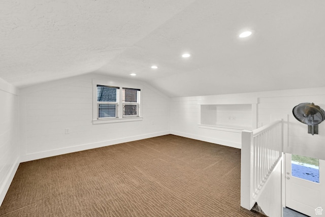 648 W Porter Ln, Centerville, UT 84014 - bonus room featuring vaulted ceiling, dark carpet, recessed lighting, and a textured ceiling