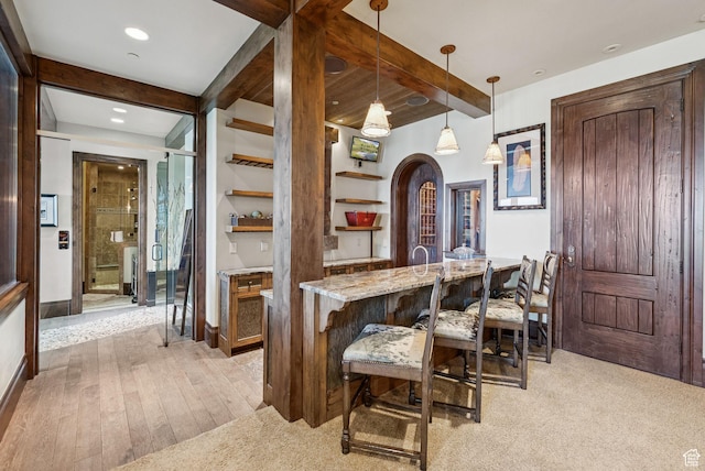 10399 Summit View Dr N, Park City, UT 84060 - dining area featuring beam ceiling, light wood-style flooring, arched walkways, recessed lighting, and bar
