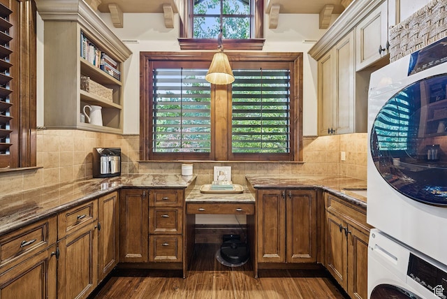10399 Summit View Dr N, Park City, UT 84060 - kitchen featuring stacked washer / drying machine, dark stone countertops, backsplash, and healthy amount of natural light