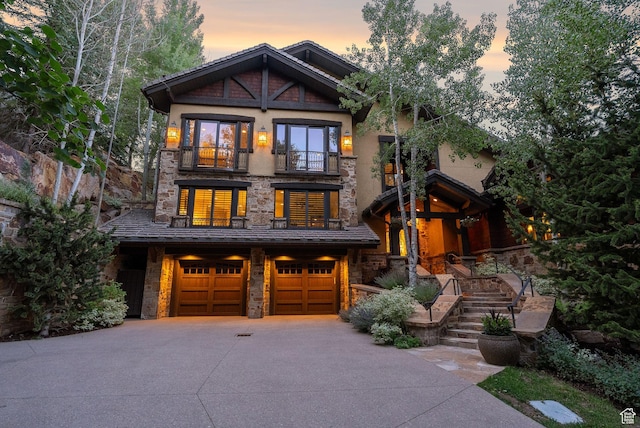 10399 Summit View Dr N, Park City, UT 84060 - craftsman-style house with a balcony, stone siding, concrete driveway, and an attached garage