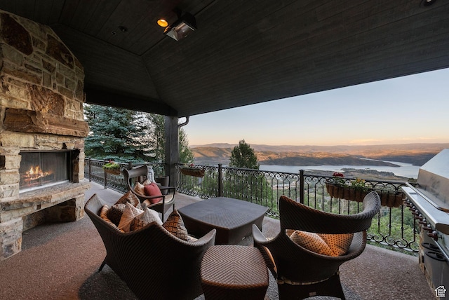 10399 Summit View Dr N, Park City, UT 84060 - balcony featuring an outdoor stone fireplace, area for grilling, and a water view