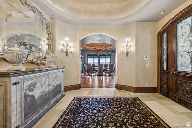 10399 Summit View Dr N, Park City, UT 84060 - foyer entrance with arched walkways, a chandelier, and a tray ceiling