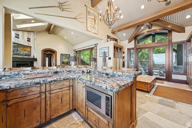 10399 Summit View Dr N, Park City, UT 84060 - kitchen with stone tile flooring, beam ceiling, a fireplace, high vaulted ceiling, and open floor plan