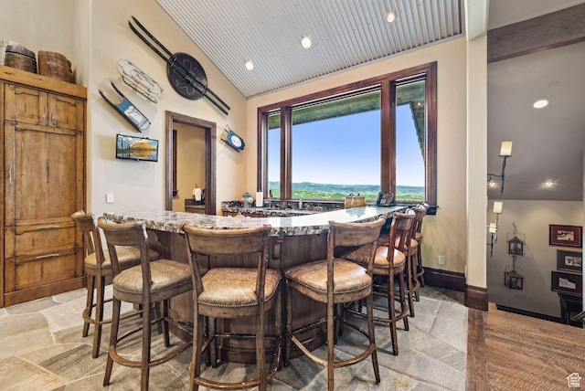 10399 Summit View Dr N, Park City, UT 84060 - indoor bar featuring stone tile flooring, vaulted ceiling, and recessed lighting