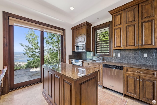 10399 Summit View Dr N, Park City, UT 84060 - kitchen featuring stainless steel appliances, tasteful backsplash, dark stone counters, and a center island