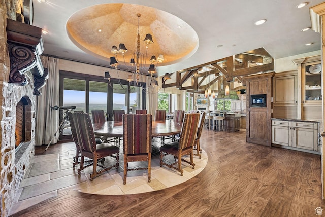 10399 Summit View Dr N, Park City, UT 84060 - dining area with a raised ceiling, dark wood-type flooring, recessed lighting, a chandelier, and a fireplace