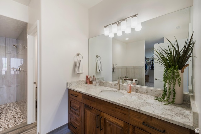 5336 W 3180 S, Hurricane, UT 84737 - full bath featuring a tile shower, vanity, and wood finished floors