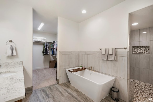 5336 W 3180 S, Hurricane, UT 84737 - bathroom with a soaking tub, wood finished floors, vanity, a spacious closet, and a walk in shower