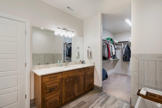 5336 W 3180 S, Hurricane, UT 84737 - full bathroom featuring a spacious closet, vanity, and wood finished floors