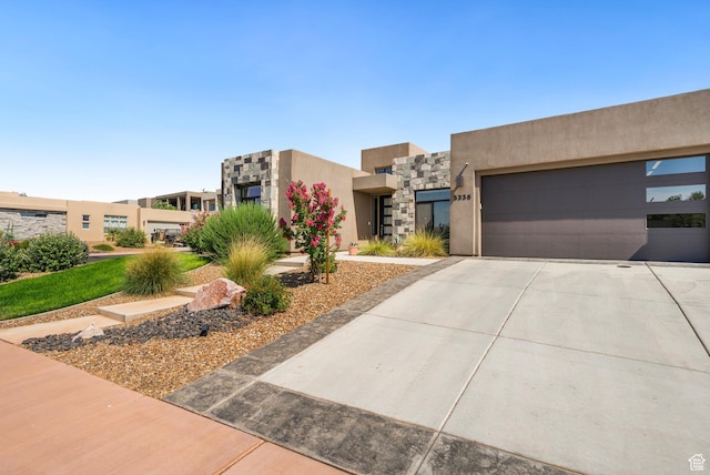 5336 W 3180 S, Hurricane, UT 84737 - southwest-style home featuring driveway, stucco siding, stone siding, and a garage