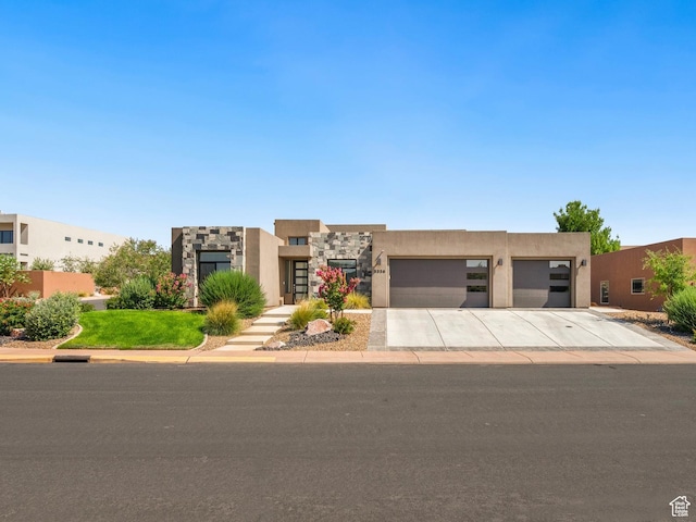 5336 W 3180 S, Hurricane, UT 84737 - adobe home featuring stucco siding, concrete driveway, and a garage