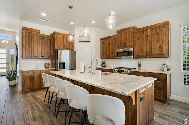 5336 W 3180 S, Hurricane, UT 84737 - kitchen featuring stainless steel appliances, dark wood finished floors, backsplash, a breakfast bar, and recessed lighting