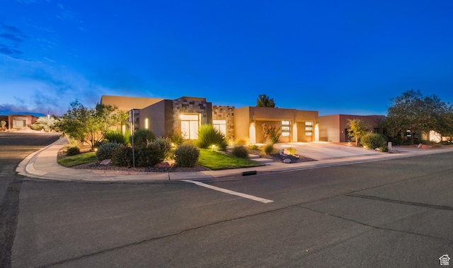 5336 W 3180 S, Hurricane, UT 84737 - adobe home with driveway, stucco siding, and an attached garage