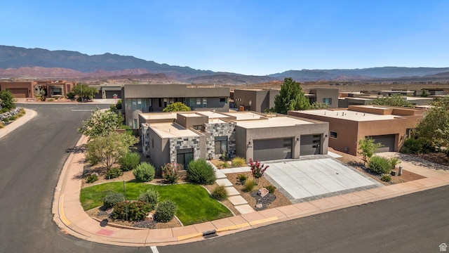 5336 W 3180 S, Hurricane, UT 84737 - view of front of property featuring stucco siding, driveway, a mountain view, a residential view, and an attached garage