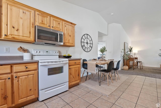 1674 E Ridgefield Rd, Spanish Fork, UT 84660 - kitchen with white electric range oven, stainless steel microwave, vaulted ceiling, light tile patterned flooring, and light colored carpet
