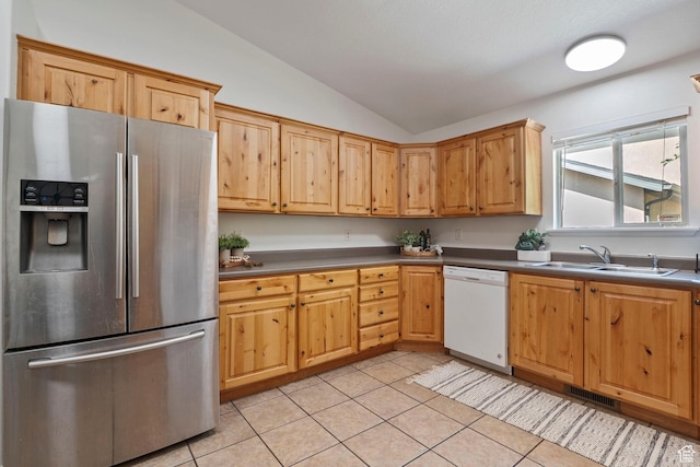 1674 E Ridgefield Rd, Spanish Fork, UT 84660 - kitchen with stainless steel fridge with ice dispenser, vaulted ceiling, white dishwasher, light tile patterned floors, and dark countertops