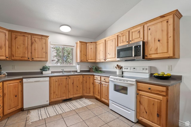 1674 E Ridgefield Rd, Spanish Fork, UT 84660 - kitchen with white appliances, lofted ceiling, light tile patterned floors, and dark countertops
