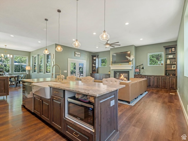 355 S 200 E, Bountiful, UT 84010 - kitchen with recessed lighting, a glass covered fireplace, dark wood-type flooring, and dark brown cabinets