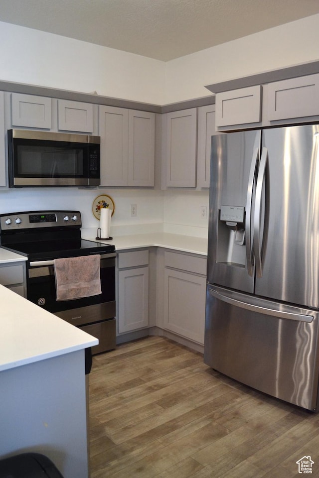 680 N 380 W Unit Z303, Vineyard, UT 84059 - kitchen featuring gray cabinets, stainless steel appliances, light wood-style flooring, and light countertops