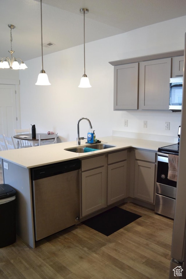 680 N 380 W Unit Z303, Vineyard, UT 84059 - kitchen with gray cabinets, a peninsula, appliances with stainless steel finishes, and dark wood-style flooring