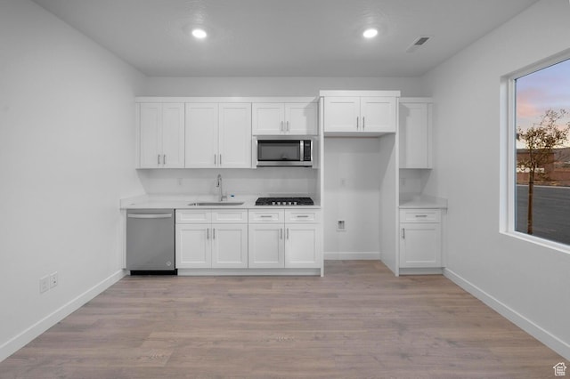 1391 S Padre Bay Dr Unit 4075, Washington, UT 84780 - kitchen featuring white cabinets, stainless steel appliances, light countertops, recessed lighting, and light wood-style floors
