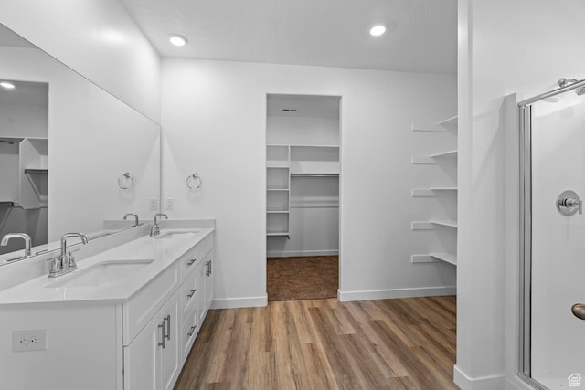 1391 S Padre Bay Dr Unit 4075, Washington, UT 84780 - full bathroom featuring double vanity, a spacious closet, wood finished floors, a stall shower, and recessed lighting
