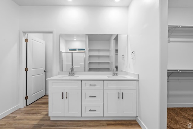 1391 S Padre Bay Dr Unit 4075, Washington, UT 84780 - bathroom with a spacious closet, double vanity, a shower stall, recessed lighting, and wood finished floors