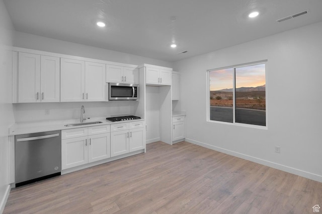 1391 S Padre Bay Dr Unit 4075, Washington, UT 84780 - kitchen with stainless steel appliances, light wood finished floors, white cabinets, light countertops, and recessed lighting