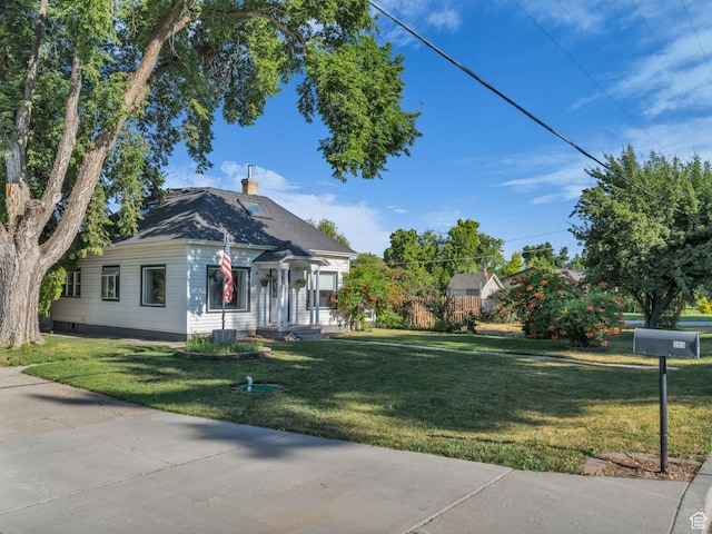 235 N 300 W, Smithfield, UT 84335 - view of front of home with a chimney and a front lawn