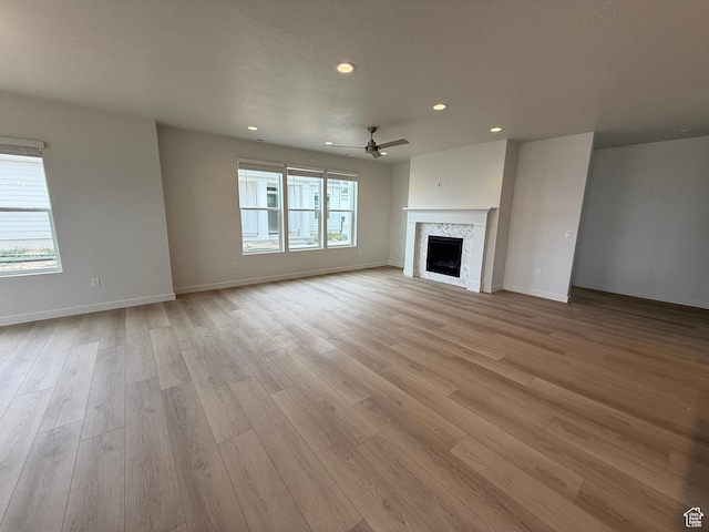 22 S 3830 W Unit 422, West Point, UT 84015 - unfurnished living room featuring recessed lighting, light wood-type flooring, a ceiling fan, and a fireplace