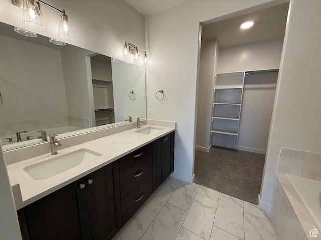 22 S 3830 W Unit 422, West Point, UT 84015 - full bathroom with double vanity, a walk in closet, a garden tub, marble finish floors, and recessed lighting