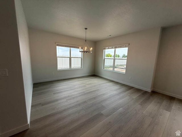 22 S 3830 W Unit 422, West Point, UT 84015 - spare room with a chandelier and wood finished floors