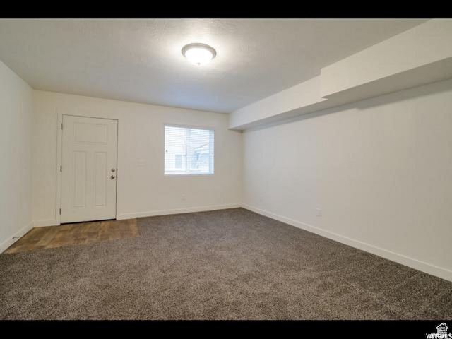 96 E 670 N, Vineyard, UT 84059 - spare room featuring dark colored carpet and baseboards