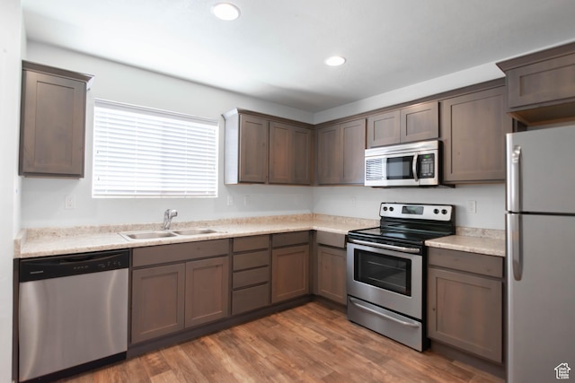 96 E 670 N, Vineyard, UT 84059 - kitchen featuring stainless steel appliances, light countertops, wood finished floors, recessed lighting, and dark brown cabinetry
