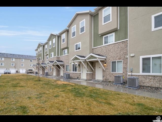 96 E 670 N, Vineyard, UT 84059 - back of house featuring stucco siding, a residential view, and a yard